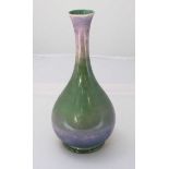 A Moorcroft pottery onion vase, decorated in a lilac and green ombre effect lustre. 26cm high.