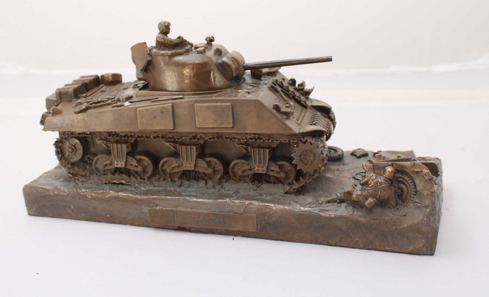 A bronze-patinated resin desk model of a Sherman M4A3 Tank, 24cm long
