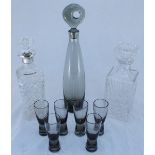 A smokey glass decanter of slender, ovoid form, possibly by Dartington and a matching set of six