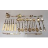 An assortment of silver flatware including a set of six ivory handled nut picks by Henry Atkin,