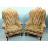 A pair of wing back armchairs with striped fabric upholstery and raised on cabriole front supports.