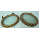A pair of early 20th century oval brass ships portholes, approx 35x48cm