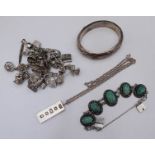 An assortment of silver items including a pair of cufflinks by 'Gieves' in original box, an ingot on