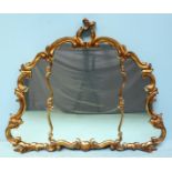 A Rococo style over-mantle mirror in carved and scrolling gilt frame. 90 x 110cm including frame.