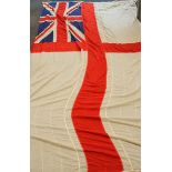 A large white ensign flag, measuring 240cm x 430cm, reputably souvenired from the Flagship HMS