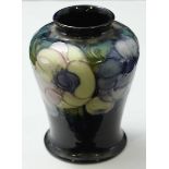 A Moorcroft pottery vase of cylindrical tapering form, with blue and white pansy decoration to a