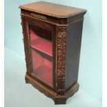 An oak pier cabinet, ornately decorated with carved flowers and a single glazed door enclosing a