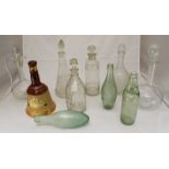 Ten various glass bottles and decanters, together with a ceramic Bells whiskey decanter.