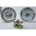 Two late 18th/early 19th century Delft plates, together with a pottery pink lustre cow creamer.