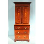 An Edwardian mahogany bedroom press, the top with a pair of doors enclosing shelves with marquetry