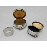 Two various silver boxes with hinged covers and a silver napkin ring. Gross weight approximately 6.