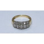 An 18ct gold and diamond ring, the top set with alternating rows of RBC and baguette cut diamonds.