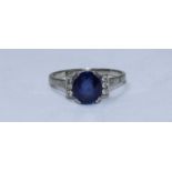 An 18ct white gold and platinum ring, centrally claw-set an oval faceted sapphire, 9.20mm x 8.10mm