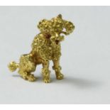 An 18ct gold brooch, modelled as a poodle, with an amethyst studded collar. Gross weight