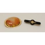 A 9ct gold brooch, centrally set with an oval agate style glass cabochon. Gross weight approximately