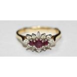 An 18ct gold, ruby and diamond cluster ring, set with three rubies, surrounded by twelve diamonds