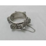 A silver stiff bangle marked 'GAL' possibly Native American Navajo and decorated with a scrolling