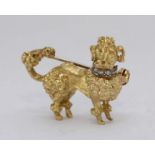 An 18ct gold brooch, modelled as a poodle, with a diamond studded collar. Gross weight approximately