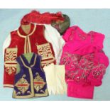 Two velvet embroidered waistcoats, pink sari, white top and trousers, traditional style hat with