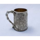 A Chinese export silver mug, Canton c.1830's, of tapered cylindrical form, with a bamboo design loop