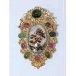 A Continental gold brooch with central oval porcelain panel painted with a tree in a landscape,