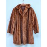 A brown fur coat. 90cm long.