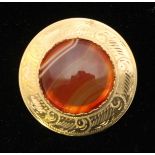 A 9ct gold brooch, centrally set with a circular agate cabochon. Gross weight approximately 10.4g.