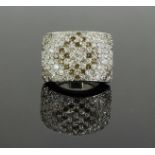 An 18 carat white gold curved panel ring pave set with thirty-six cognac and forty one white round