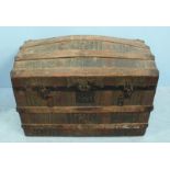 An early 20th century wood and metal-bound dome-top trunk with faux crocodile skin covering, 78cm