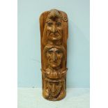 A hardwood (possibly Iroko) carved Native American inspired totem pole, modelled with three faces.