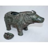 A Shang dynasty style patinated bronze ritual vessel modelled in the form of a bull, the underside