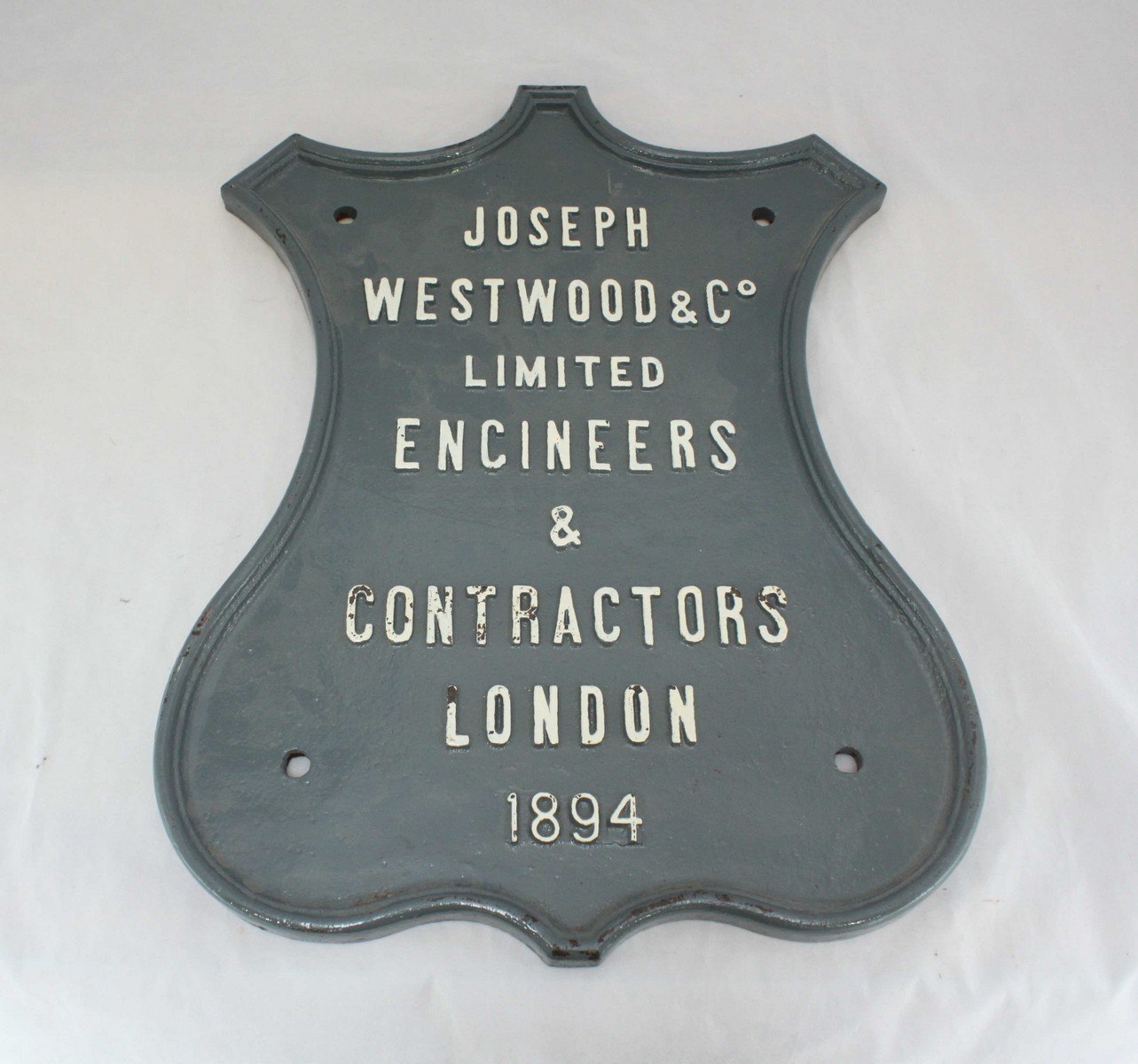 Railway Interest: A 19th century cartouche-shaped painted cast iron trade sign for 'Joseph