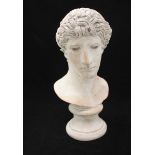 A composite sculpture of a Greek style bust, raised on turned pedestal base. 44cm high.