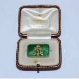 An unmarked yellow metal and enamel brooch, (probably 18ct gold), of rectangular panel form