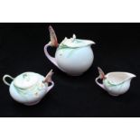 A three piece Franz porcelain tea-set comprising of a teapot, a cream jug and a sugar pot, all