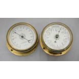 An aneroid barometer and similar thermometer by GEC, each with circular silvered dial and circular