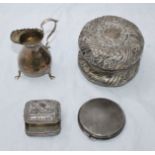 A small selection of silver items including a floral embossed pot and cover, a small jug, a small