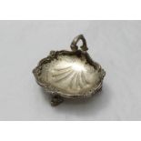 A small silver dish by Asprey and Co Ltd. modelled as a shell with scrolled handle, floral