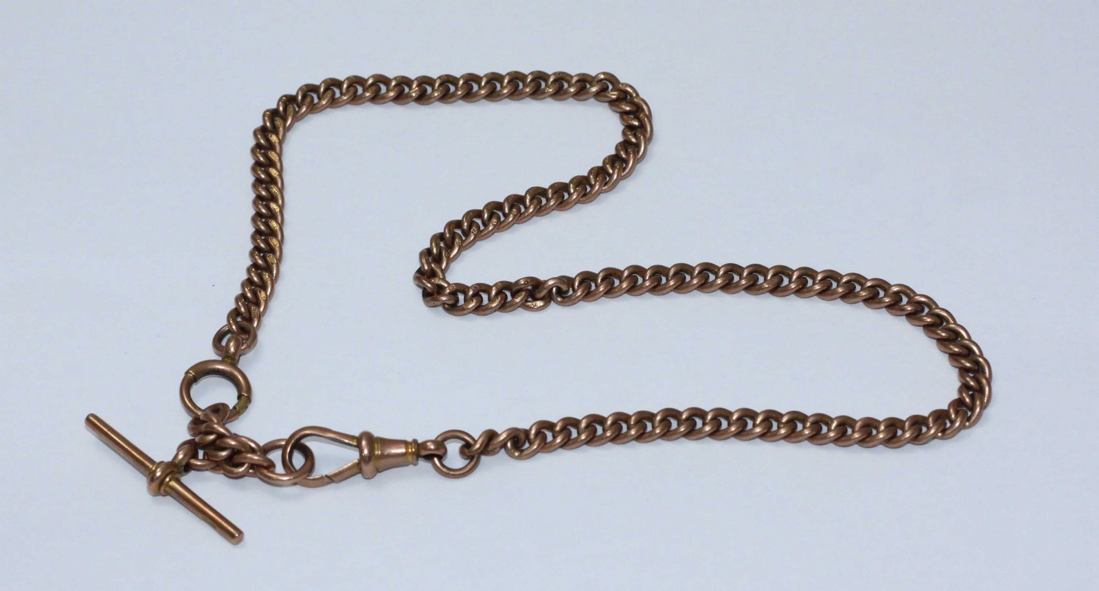 A 9ct rose gold Albert watch chain with T-bar. Gross weight approximately 38.4g.