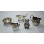 A small selection of silver items including three various jugs, a pepper and a small dish. Gross