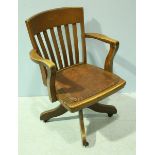 An early 20th century stained oak office swivel chair with Rexine seat