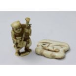 A Japanese carved ivory Netsuke of a musician playing a Shamisen, signed underside, 50mm high,