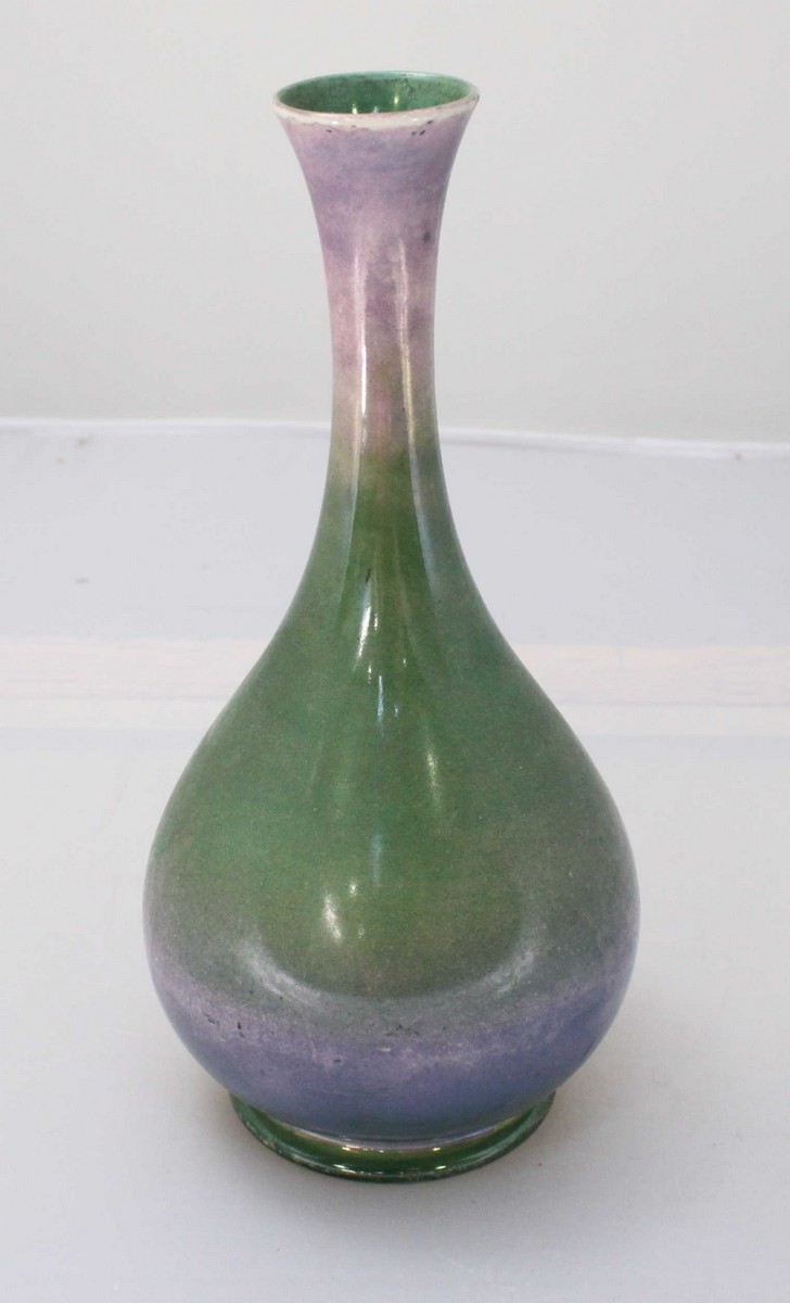 A Moorcroft pottery onion vase, decorated in a lilac and green ombre effect lustre. 26cm high.