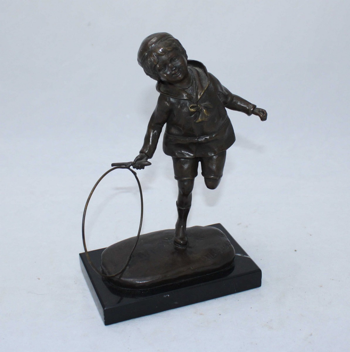 After Chiparus, bronze figure of a boy with a hoop, approximately 21cm high