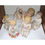 SECTION 27. Five various unglazed bisque porcelain piano babies