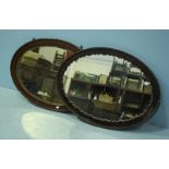 Two large mahogany oval mirrors. The largest measuring 98cm.