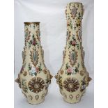 A pair of Zsolnay vases of ovoid form with cylindrical necks, floral decoration and applied