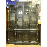 A Late 19th Century Ebonised Breakfront Bookcase, by Gillows, with dentil-moulded cornice above four