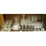 A shelf of assorted mixed glassware including a quantity of wine glasses and other drinking glass, a