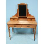 An Edwardian pine dressing table with frieze drawers, bevelled cheval mirror and turned supports,